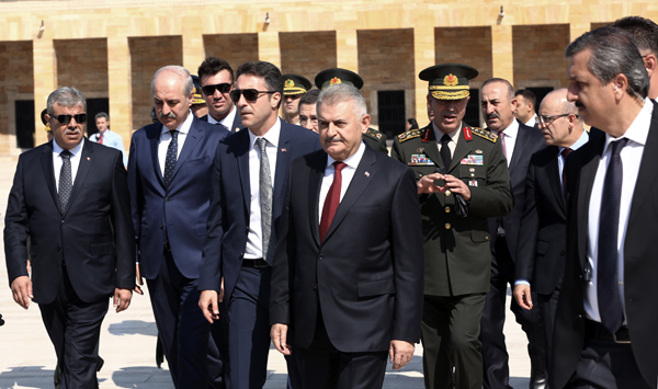 Turkish Prime Minister Binali Yildirim (front-centre), military commanders and ministers walk to the mausoleum of Turkey's founder Kemal Ataturk to pay respects in Ankara, Turkey, on Tuesday (AP photo)
